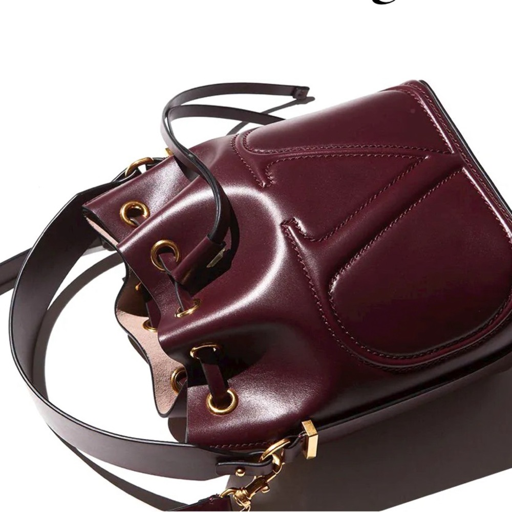 BUYING: Valentino Vlogo bucket bag, preferably in this burgundy color.